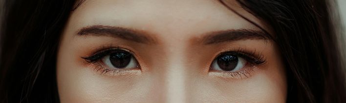 A detailed close-up image showcasing the expressive eyes and natural beauty of a young woman.